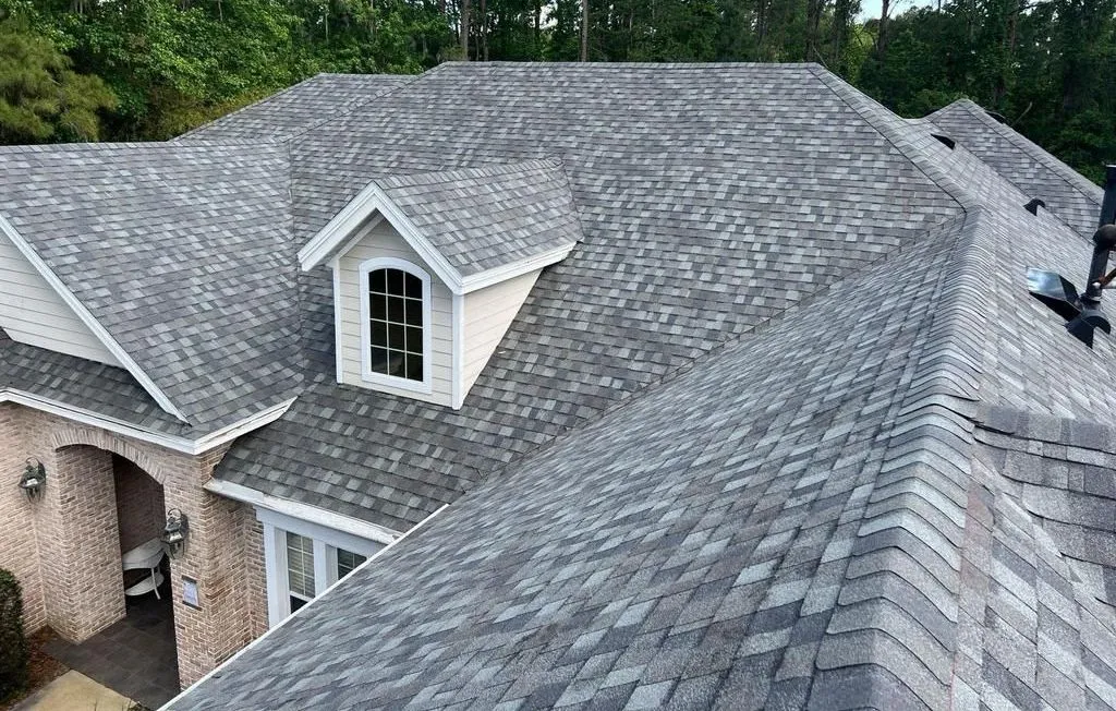 Crew installing asphalt shingles